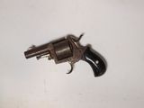 a small gun that is on a white surface