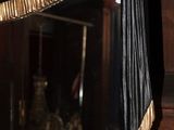 a mirror that has a black and gold decoration on it