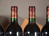 three bottles of wine are lined up on a table