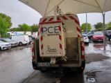 a truck that is parked under an umbrella in the rain