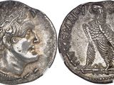 a silver coin with an image of a woman and a bird on it