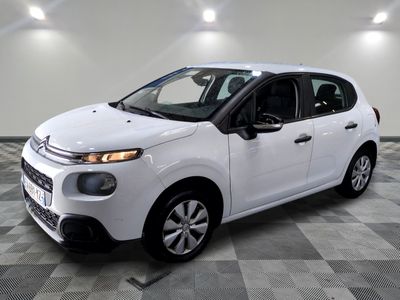 the white citrole is parked on a checkered tile floor