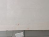 a picture of a bathroom with a toilet and a mirror