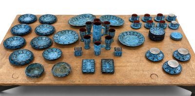 a table with a lot of blue plates and bowls on it