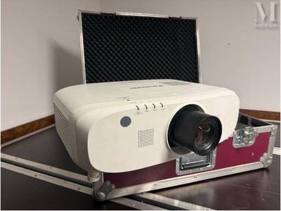 a white projector sitting in a case on a table