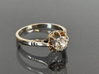 a close up of a diamond ring on a black surface