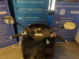 a scooter that is parked in front of a blue sign