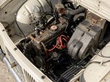 a small engine in the trunk of an old car