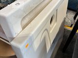 an image of a white refrigerator in a garage