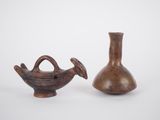 two brown vases sitting next to each other on a white surface