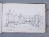 an open book with a drawing of a house in the background