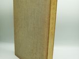 an old book sitting on top of a white surface