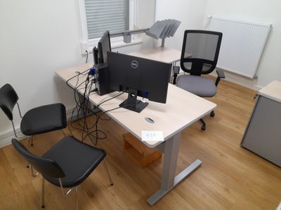 an image of a desk with a computer and two chairs