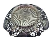 an image of a silver plate with a flower design on it