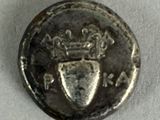 an old coin with a crown and shield on it