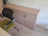 a desk with a chair and a cabinet in the corner