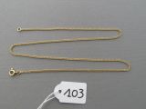 a close up of a gold chain with a price tag on it