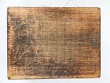 a piece of wood that has been scratched and is hanging on a wall
