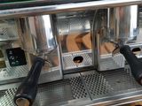 a close up of a coffee machine on a wooden pallet