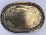 an image of a silver plate with a design on it