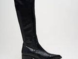 a black boot that is sitting on a white surface