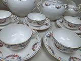 a lot of tea cups and saucers sitting on a table