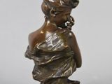 bronze statue of a woman holding a baby on a marble base