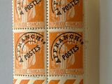 an orange and black stamp on a piece of paper with a picture of a woman