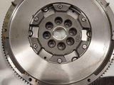 clutch plate and flywheel of a car on a white surface