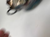 a close up of a person ' s hand holding a tea pot