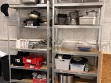 many pots and pans on the shelves in the kitchen
