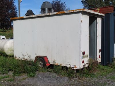 an image of a white trailer parked in a field