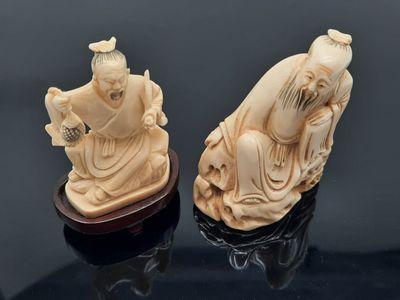 two carved ivory figurines of a man and a woman