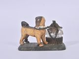 a small statue of a dog with a basket on it