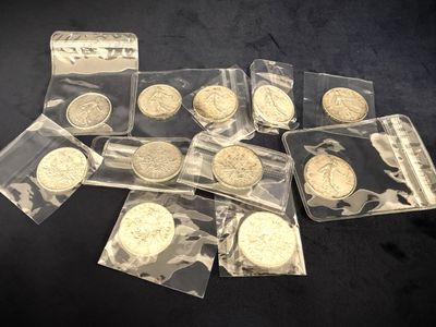 several coins are in a bag on a black surface
