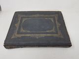 an old book sitting on top of a white table