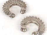 pair of silver plated ear cuffs with a sunflower design
