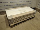 a pile of white sheets on a pallet in a room