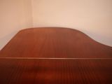 a wooden table with a glass top in a room