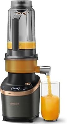 a blender with a glass of orange juice next to it