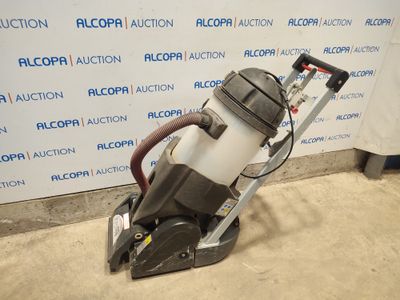 a close up of a vacuum cleaner on the ground near a wall