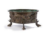 an old bronze bowl with a dragon design on it