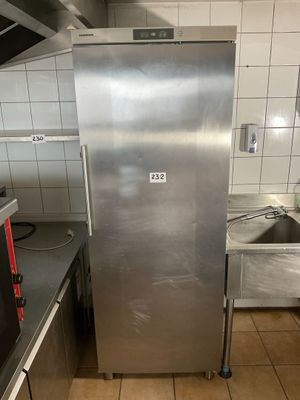 a stainless steel refrigerator in the middle of a kitchen