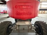 a red tractor that is parked inside of a building