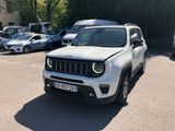 the white jeep is parked in a parking lot with other cars
