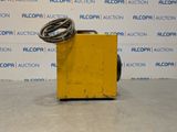 an image of a yellow box with a hose attached to it
