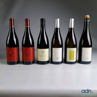 several bottles of wine are lined up on a table