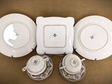 three plates and two cups sitting on a table