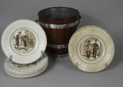 three plates and a bucket with a picture of a man and a woman on them