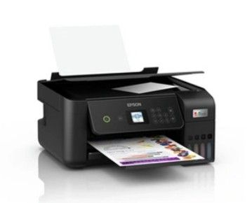 the printer is sitting on a white surface next to a piece of paper